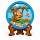 Colourful round monkey tree DIY craft plaque with butterfly, flowers and stone details displayed on decorative stand