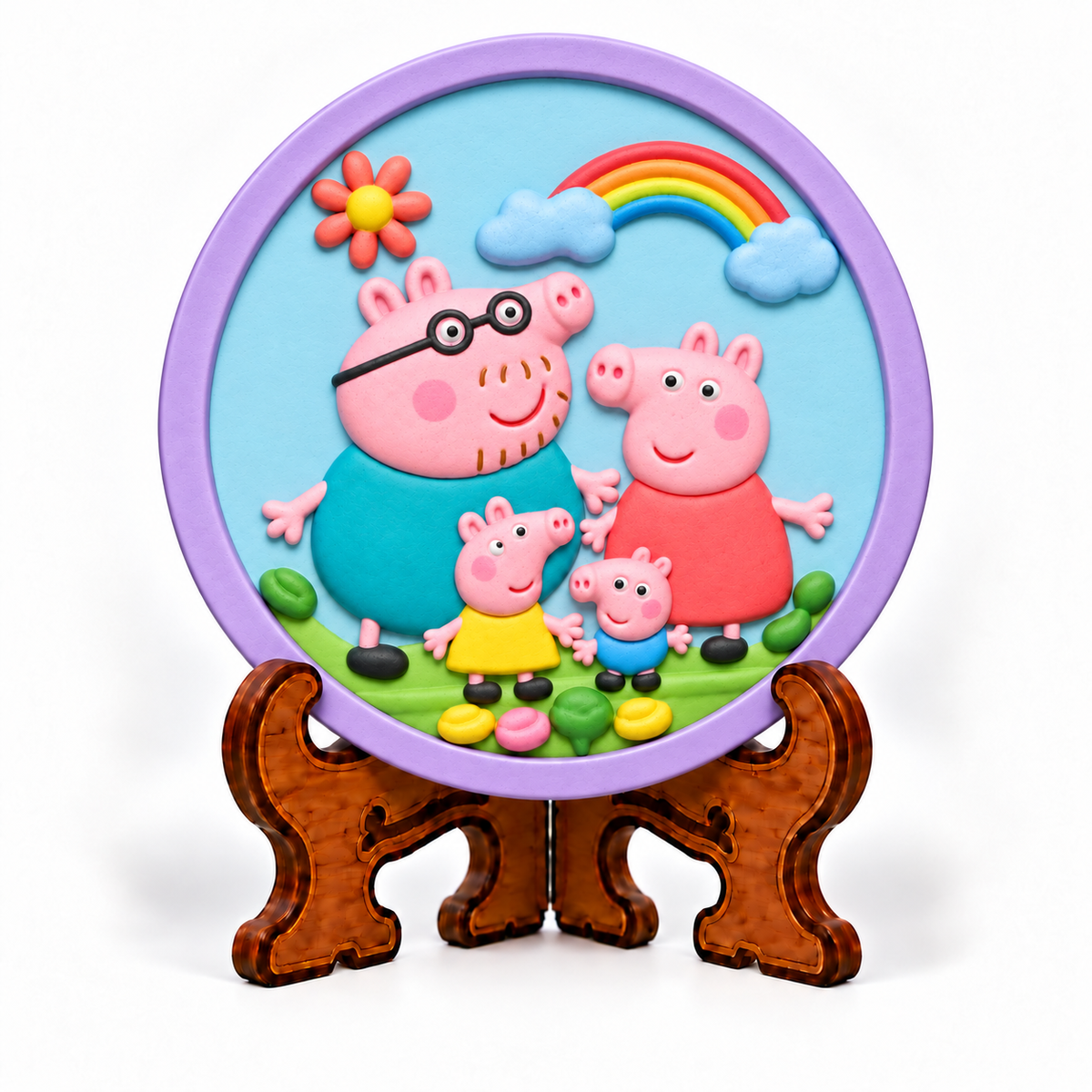 Colourful round DIY pig family craft plaque with rainbow, clouds and flowers displayed on decorative stand