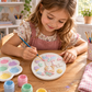 Child painting girl character DIY POP craft with pastel colours