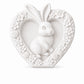Unpainted white heart-shaped bunny craft with raised floral details