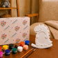 White dinosaur DIY photo frame with paint pots and brushes