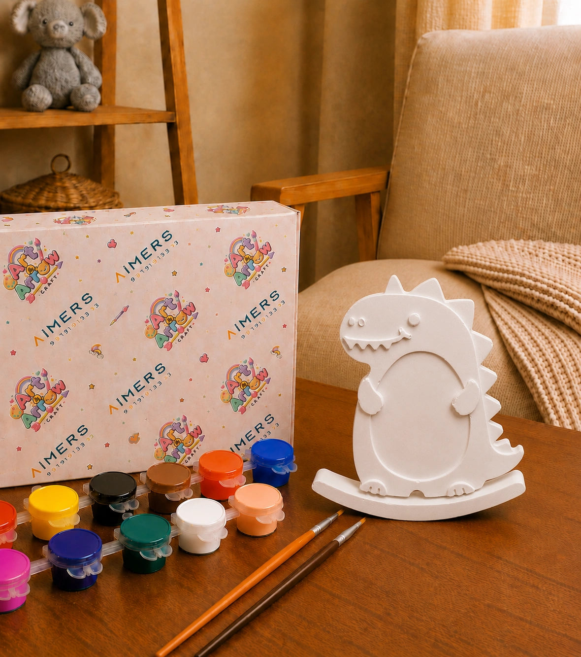 White dinosaur DIY photo frame with paint pots and brushes
