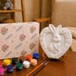 Unpainted bunny heart craft displayed with paint pots and brushes