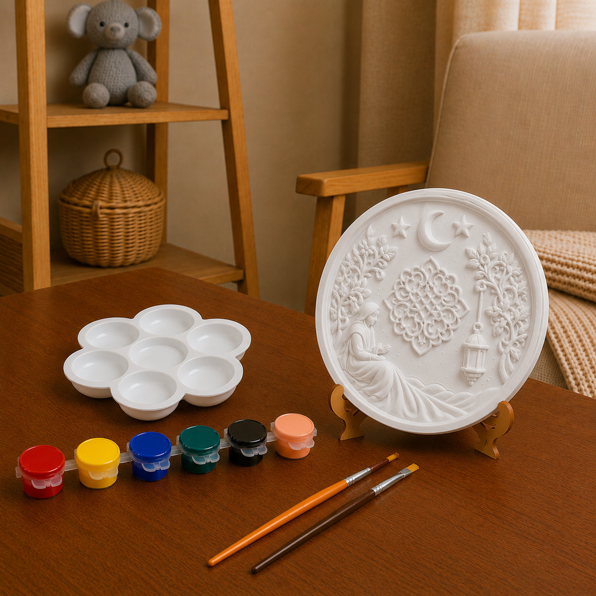 Unpainted moon and lantern DIY craft with paint pots, palette and brushes.